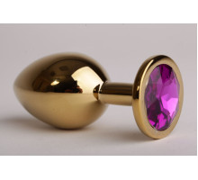 Золотистая анальная пробка с филетовым кристаллом - 8,2 см. (фиолетовый)
