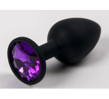Черная силиконовая анальная пробка с фиолетовым стразом - 7,1 см. (фиолетовый с черным)