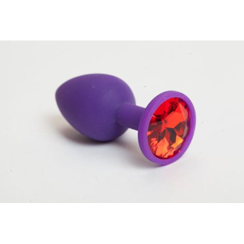 Фиолетовая силиконовая анальная пробка с красным стразом - 7,1 см. (красный)