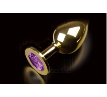 Большая золотая анальная пробка с закругленным кончиком и фиолетовым кристаллом - 9 см. (фиолетовый)