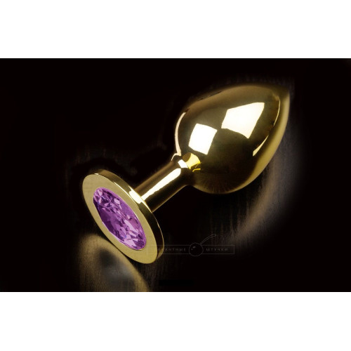 Большая золотая анальная пробка с закругленным кончиком и фиолетовым кристаллом - 9 см. (фиолетовый)