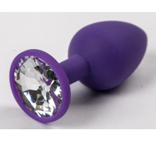 Фиолетовая силиконовая анальная пробка с прозрачным стразом - 7,1 см. (прозрачный)